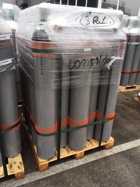 50 liter grey cylinders packed on a wodden pallet with straps with orange cylinder protection net